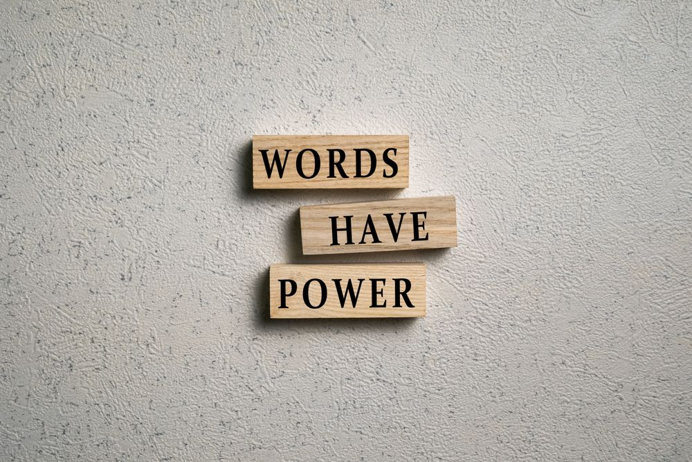 words have power words on wooden blocks on cement background