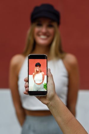 Woman having photo taken on phone