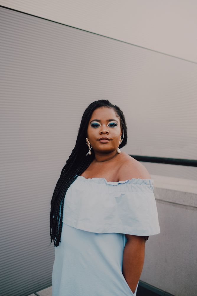 Content trendy Black woman on wall