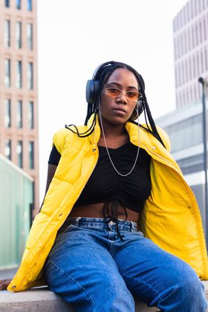 Glad Black female listening to music in city
