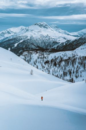 Person walking on snow covered mountain