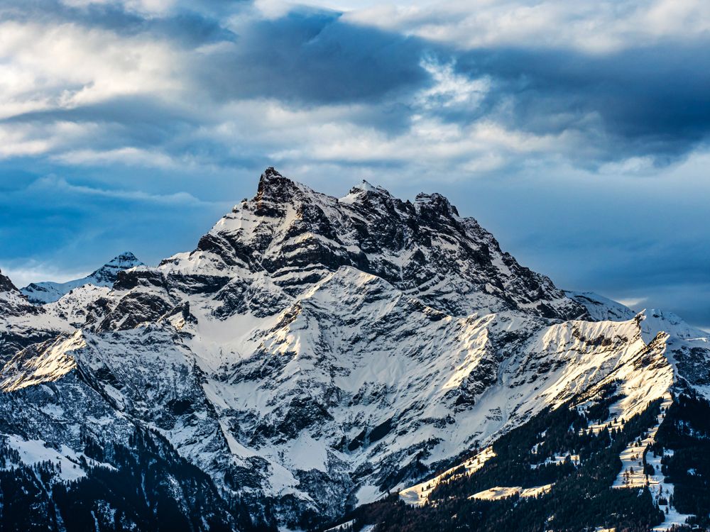 Swiss Alps winter landscape with snow and sun, mountains in Europe