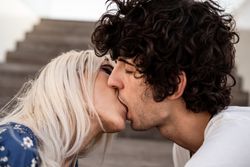 Loving couple kissing on stairs