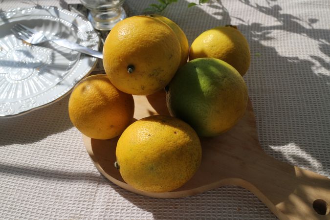 Fresh lemons from garden on wood board, on the table