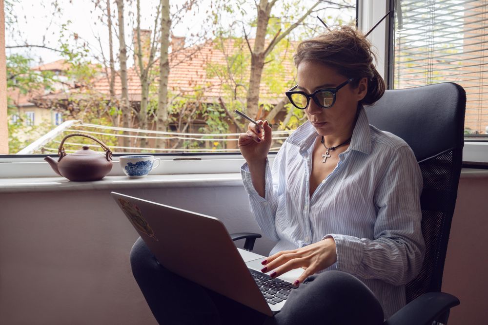 Woman with laptop smoking