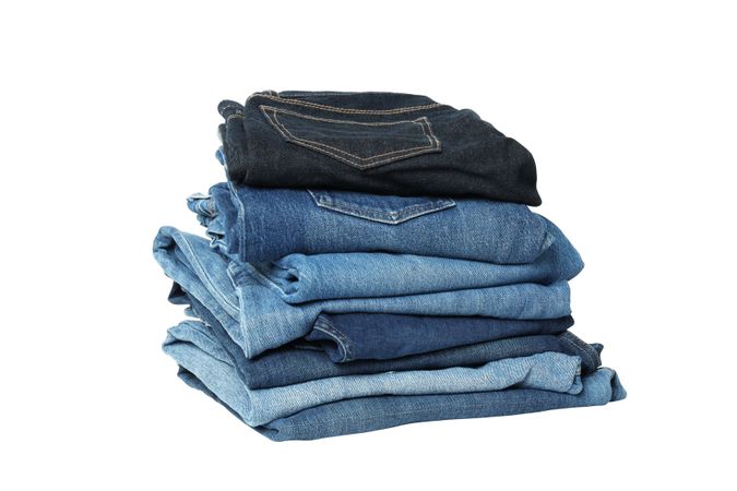 Folded jeans, isolated on light background