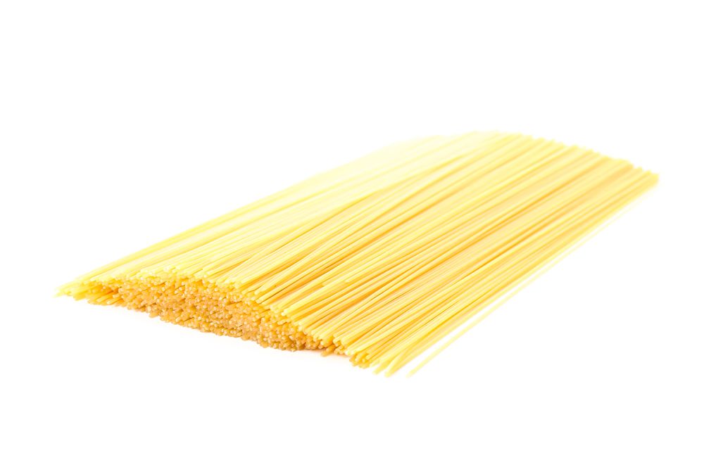 Pasta isolated on bright background, closeup. Dry uncooked whole pasta