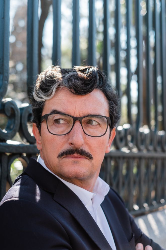 Mature accomplished businessman waiting for meeting on bench outdoors