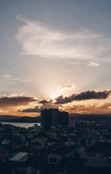 Cityscape near water and beautiful sky in evening