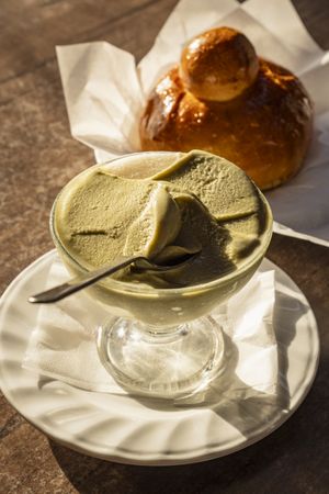 Sicilian pistachio granita with brioche served on outdoor table at golden hour