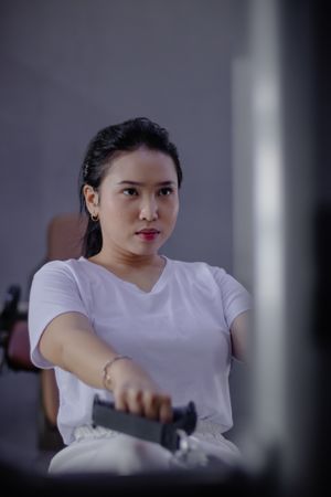Focused Athlete Doing Rowing Exercise in the Gym Studio Center