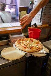 Pizza on a shovel fresh from the oven