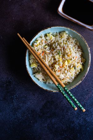 Bowl of egg fried rice with chopsticks