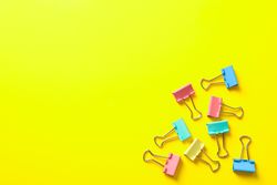 Flat lay composition with clips on color background, space for text