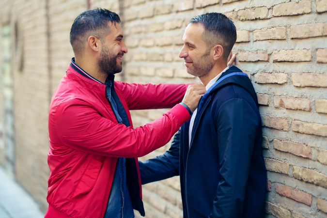 Side view of gay couple in a romantic moment on the street