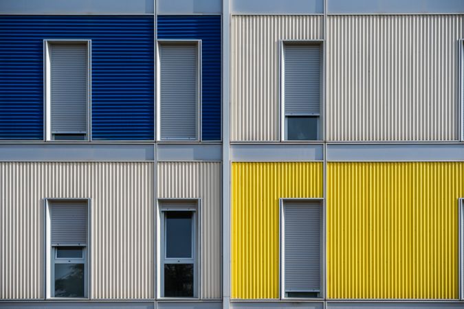 Facade of modern multicolored building with narrow windows