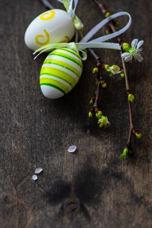 Easter holiday card concept with decorated eggs and budding branch
