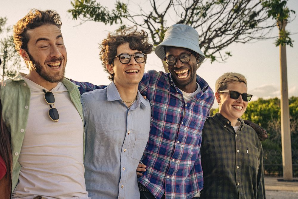 Happy friends enjoying outdoor laughter on a bright day together