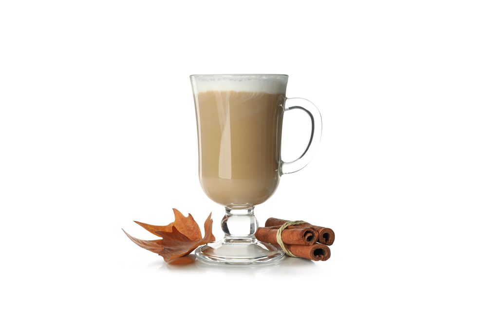 Glass cup of latte isolated on neutral background