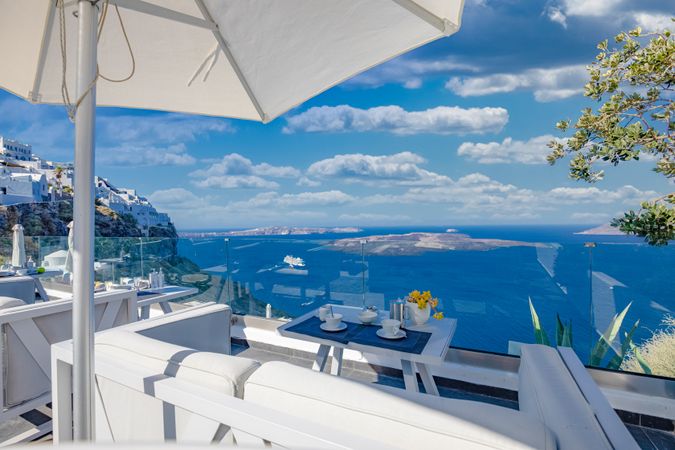 Beautiful view of islands in Greece with coffee set up on table