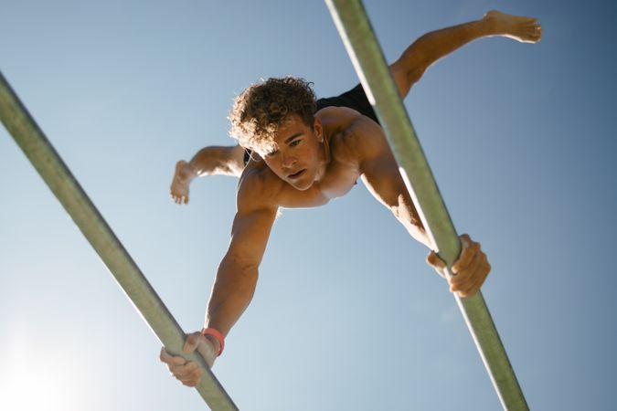 Strong young sportsman doing calisthenics