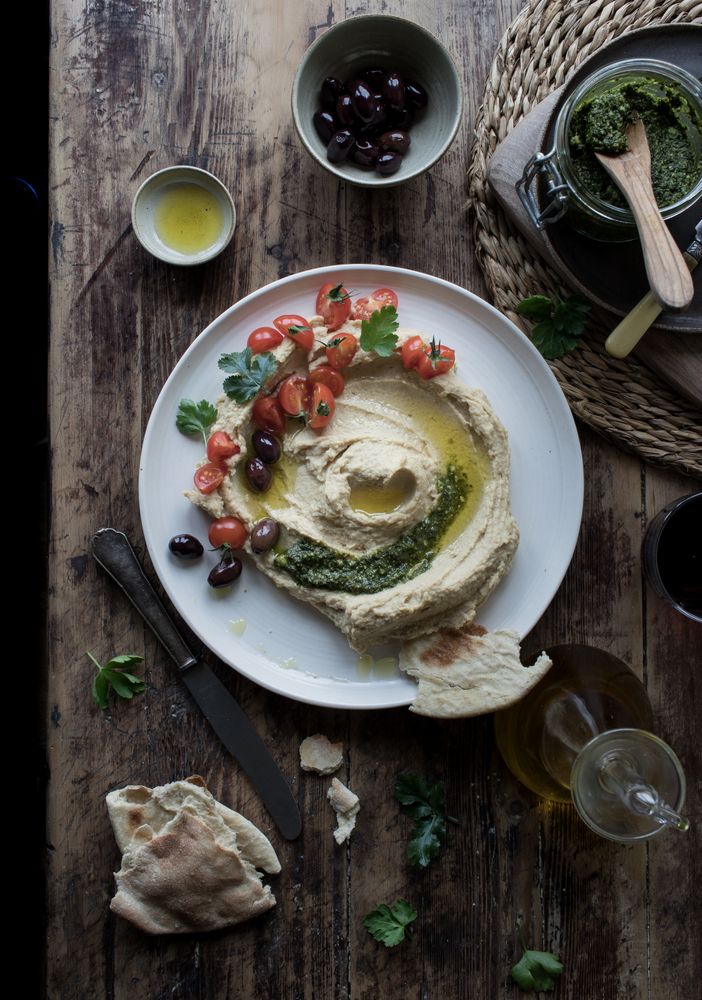 Pesto hummus with tomatoes and beans