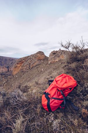 Bright backpack at mountain slope