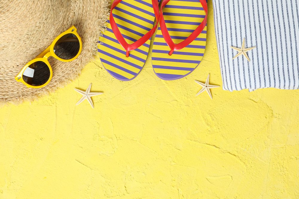 Summer vacation accessories on color background, space for text and top view. Happy holidays