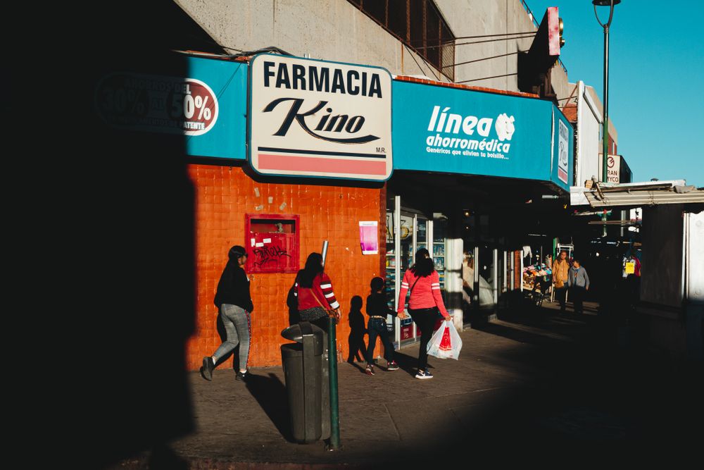 People walking on sidewalk in the city during daytime