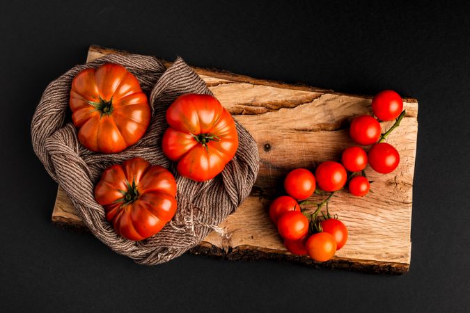 Tomatoes and napkin on wooden board