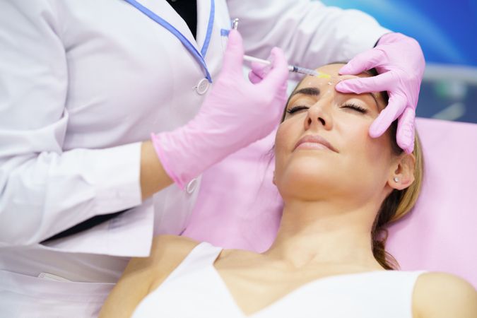 Woman in medical spa having her face injected