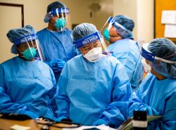 Orange County, CA, USA -April 26, 2020: Ensign Na Ha discusses patient info with her team