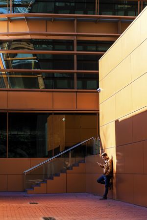 Man using mobile phone in modern building