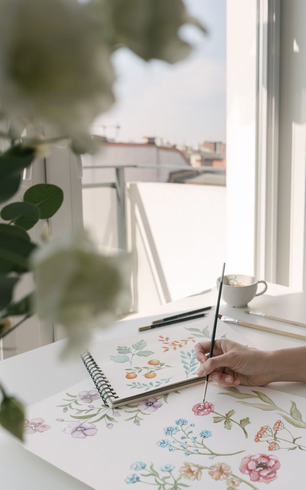 Person drawing flowers with watercolor