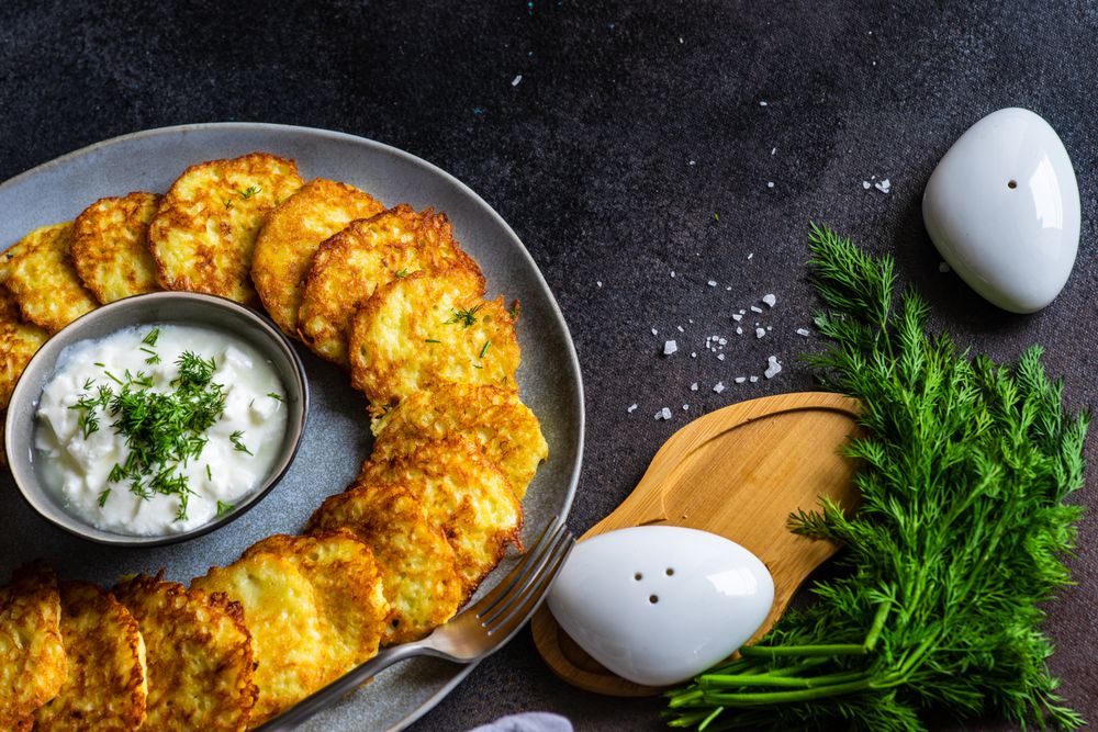 Top view of traditional Ukrainian dish deruny with condiment and salt & pepper