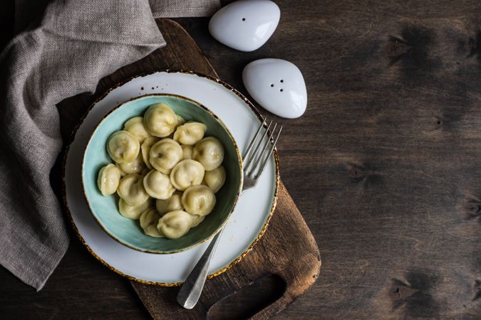 Top view of bowl of Russian dumplings with copy space