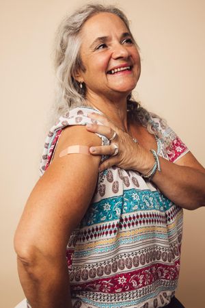 Grey haired woman after receiving vaccination
