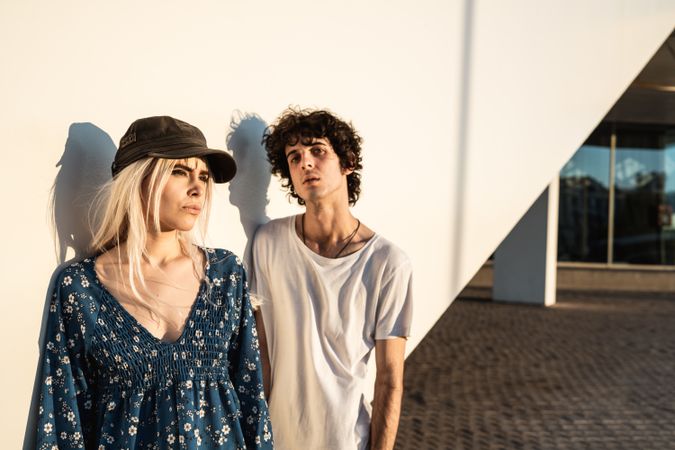 Couple leaning on wall contemplating