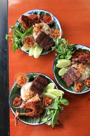 Top View Three Plate of Nasi Ayam Rempah with Tempeh Bakar