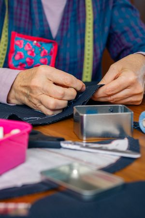 female seamstress sewing cloth