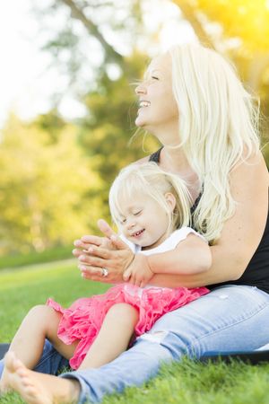 Mother and Little Girl Having Fun Together in Grass