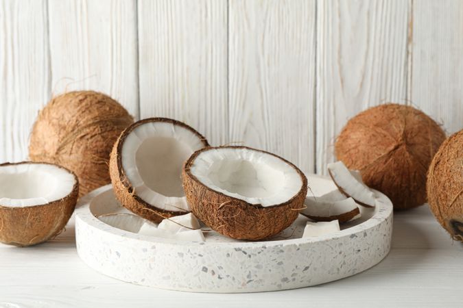 Tray with coconut on wooden background. Tropical fruit