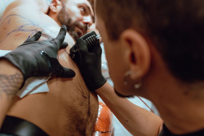 Stylish man getting tattoo
