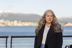 Professional woman standing outside in front of a bay