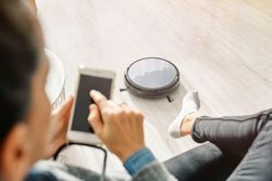 Female browsing smartphone and sitting on sofa