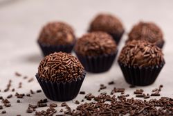 Close up of chocolate truffles with sprinkles on marble table