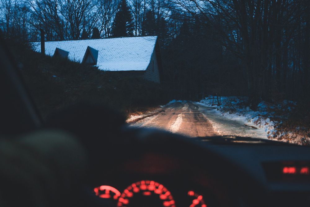 Crop hand driving car in winter village