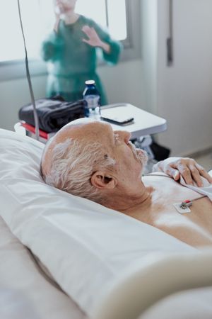 Older man admitted to a hospital room.
