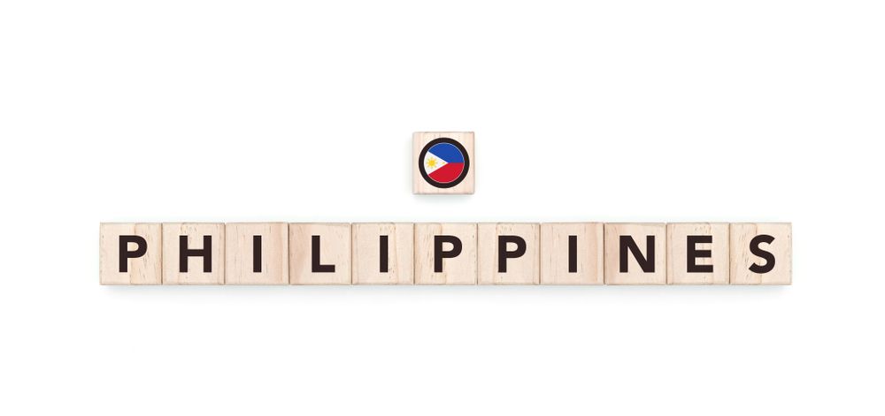 Wooden blocks bearing the name and flag of Philippines. Filipino and Asian Culture, national identity, travel, and geography in a copy space design.