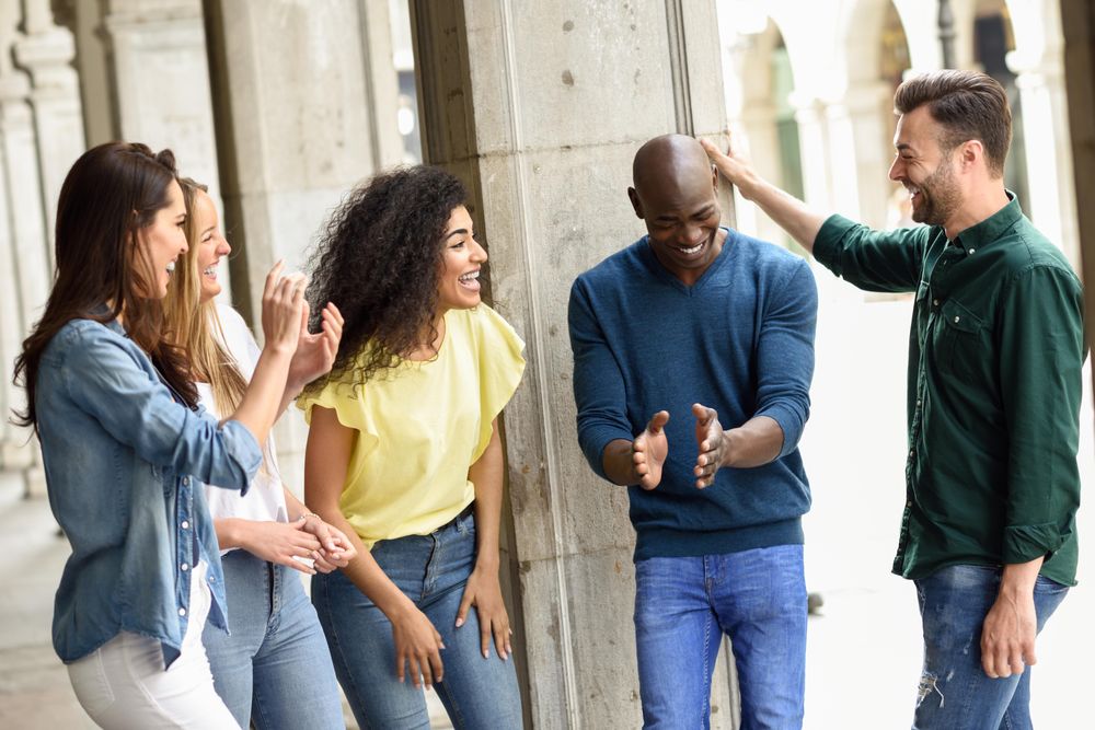 Friends standing outside having a conversation